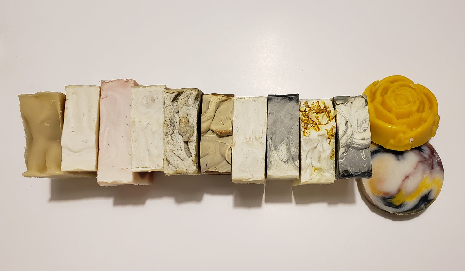 row of various handcrafted soaps