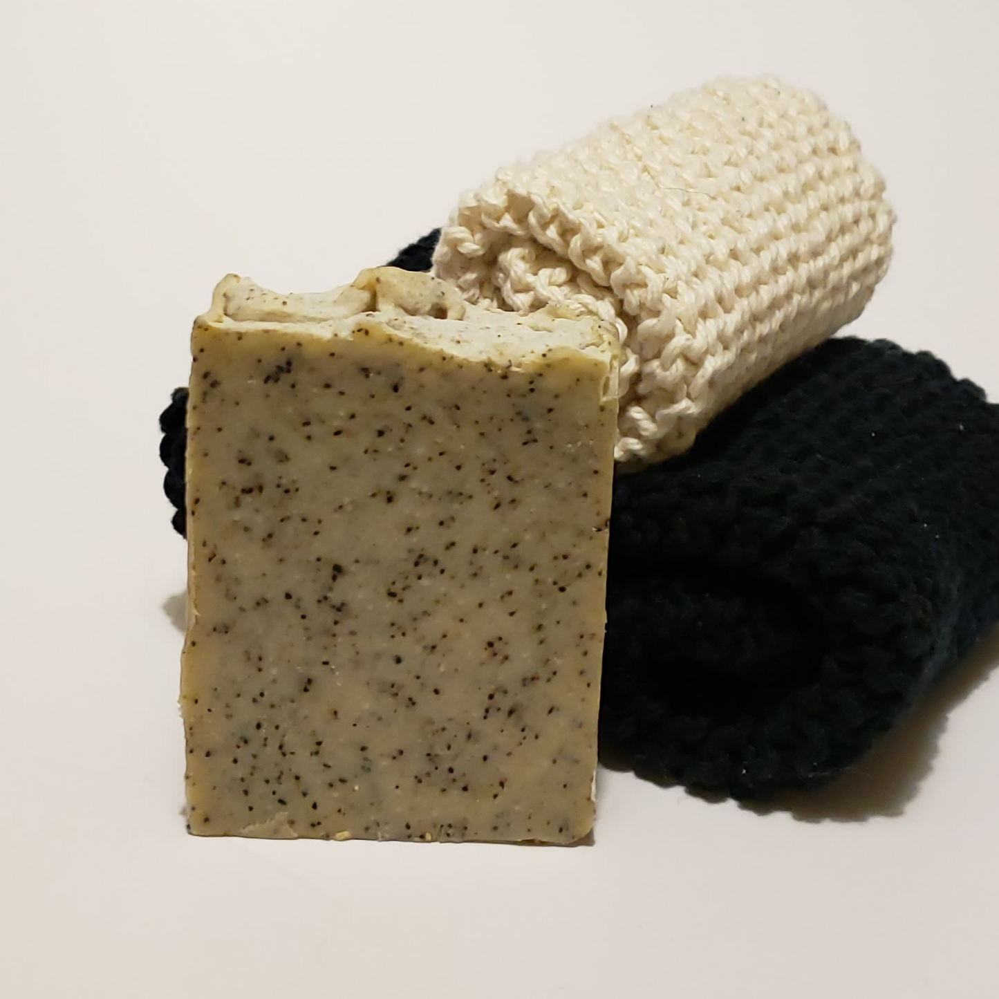 Speckled soap next to three cloths