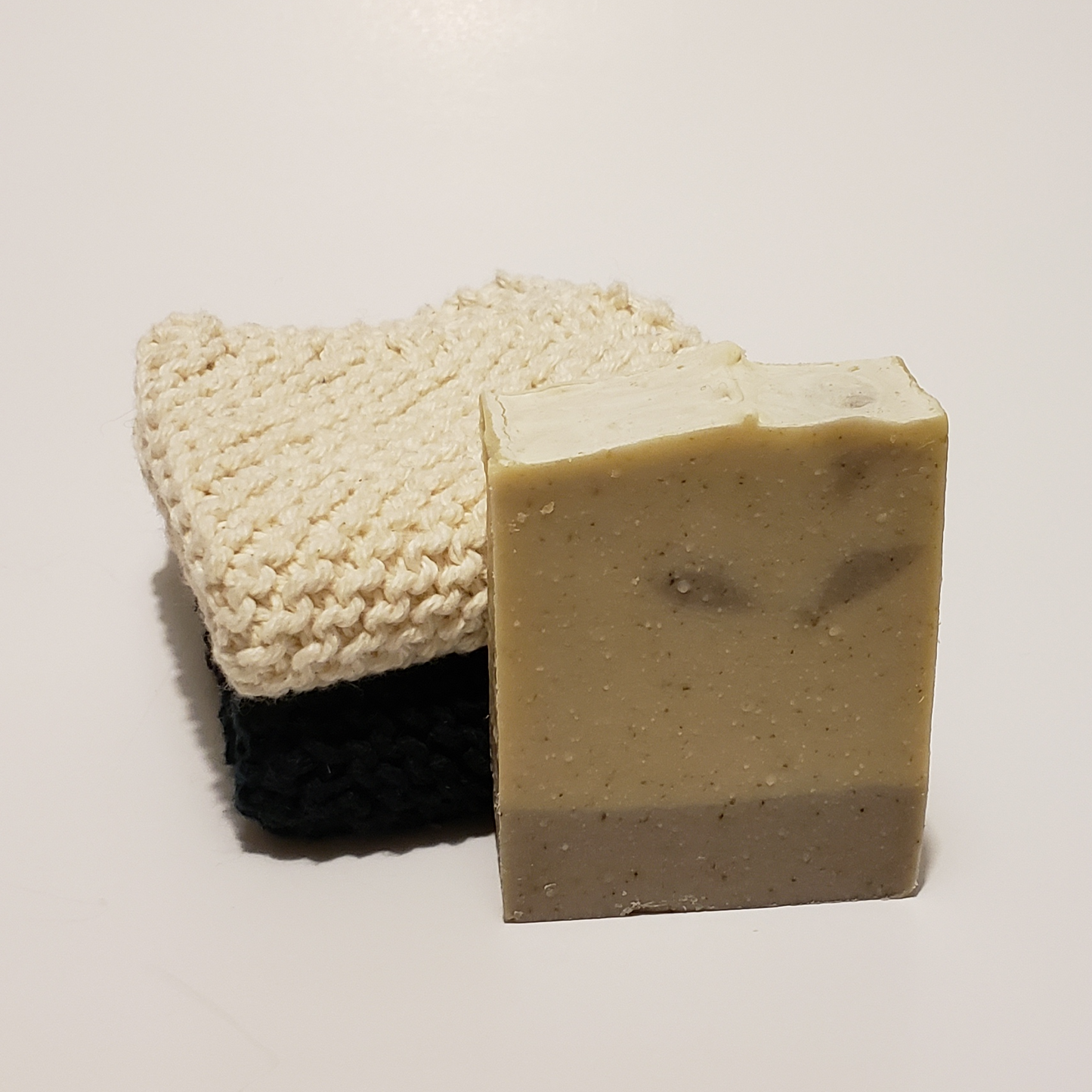 Two toned soap next to two cloths